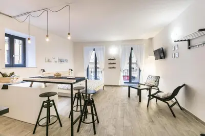 a kitchen and living room with a table and chairs at Vuccirihouse in Palermo