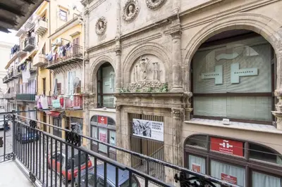 a building on a street with a balcony at Vuccirihouse in Palermo