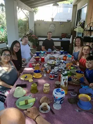 a group of people sitting around a table at The Garden in Sferracavallo