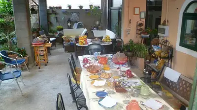 a table with plates and dishes on it in a room at The Garden in Sferracavallo