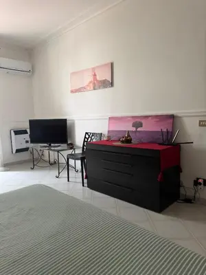 a living room with a dresser and a television at CASA CRETTO in Salaparuta