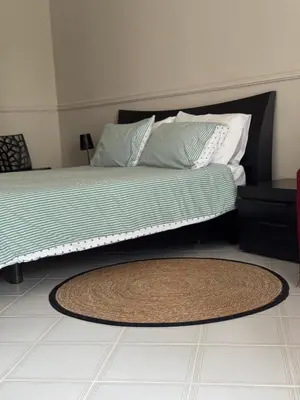 a bedroom with a bed with a rug on the floor at CASA CRETTO in Salaparuta