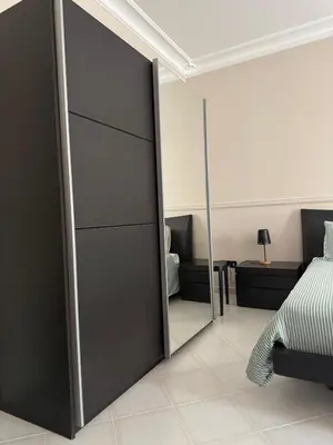 a sliding door in a bedroom with a bed and a mirror at CASA CRETTO in Salaparuta