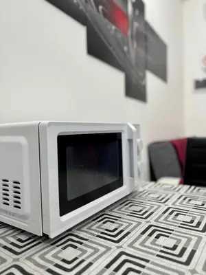 a microwave oven sitting on top of a table at Casa vacanze La Bonta' di Palermo in Palermo