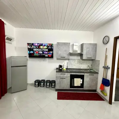 a kitchen with a sink and a refrigerator at Casa vacanze La Bonta' di Palermo in Palermo