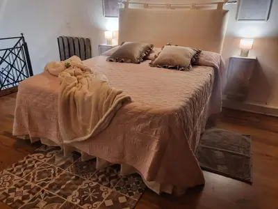 a large bed with a blanket and pillows on it at Patrizia Chic in Palermo