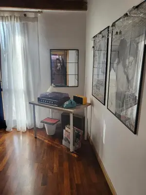 a room with a table and a mirror on a wall at Patrizia Chic in Palermo