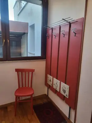 a red locker room with a red chair and a window at Patrizia Chic in Palermo