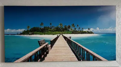 a wooden bridge leading to an island in the ocean at Casa del Limone in Isola delle Femmine
