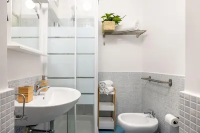 a bathroom with a sink and a toilet at Agata & Rosalia 2 Suite Indipendenti e Comunicanti con Balcone & AC in Palermo