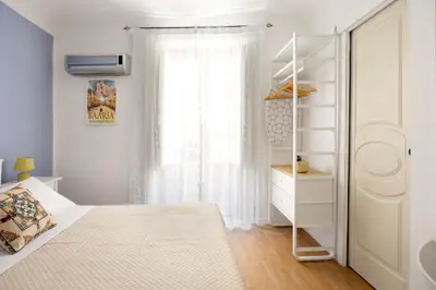 a white bedroom with a bed and a window at Agata & Rosalia 2 Suite Indipendenti e Comunicanti con Balcone & AC in Palermo