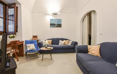 a living room with a blue couch and a table at Stunning Home In Trappeto With Wifi in Trappeto
