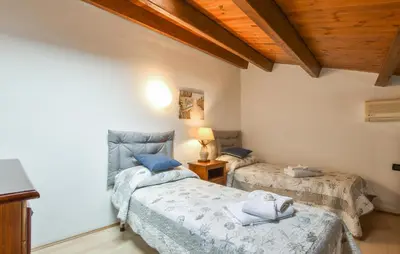 a bedroom with two beds in a room with wooden ceilings at Stunning Home In Trappeto With Wifi in Trappeto