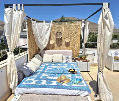 a bed on top of a balcony with a view at Villa Mondello Jacuzzi Room e Terraces Room in Mondello