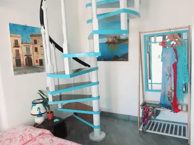 a blue and white spiral staircase in a bedroom at Villa Mondello Jacuzzi Room e Terraces Room in Mondello