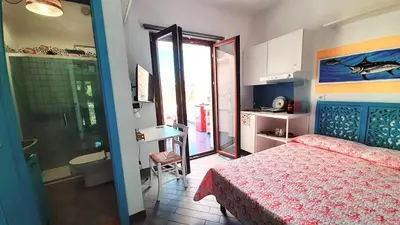 a bedroom with a bed and a bathroom with a shower at Villa Mondello Jacuzzi Room e Terraces Room in Mondello