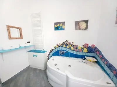a bathroom with a large white tub in a room at Villa Mondello Jacuzzi Room e Terraces Room in Mondello