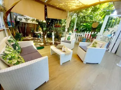 a patio with couches and chairs and a table at Villa Mondello Jacuzzi Room e Terraces Room in Mondello