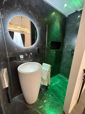 a bathroom with a sink and a mirror at Maqueda view in Palermo