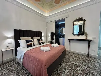 a bedroom with a large bed with two towels on it at Maqueda view in Palermo