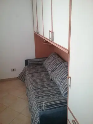 a bed with two pillows in a room at Casa Lisa in San Vito lo Capo