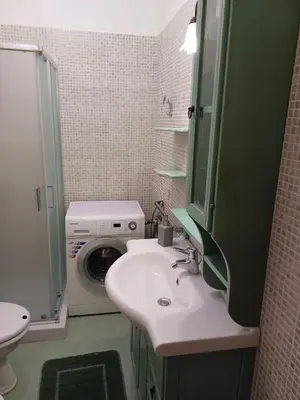 a bathroom with a sink and a washing machine at Casa Lisa in San Vito lo Capo