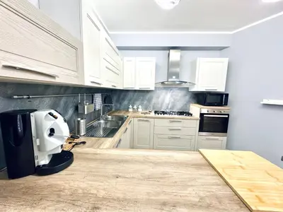 a kitchen with white cabinets and a white appliance at Ventu di Sciroccu in Cinisi