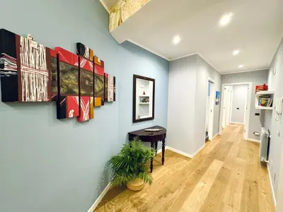 a hallway with blue walls and a table and a plant at Ventu di Sciroccu in Cinisi