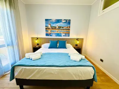 a bedroom with a large bed with blue pillows at Ventu di Sciroccu in Cinisi