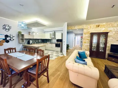 a living room with a dining table and a kitchen at Ventu di Sciroccu in Cinisi