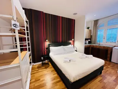 a bedroom with a bed with white sheets and a ladder at Ashur 163 - Mondello in Palermo