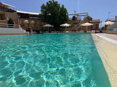 a large swimming pool with turquoise blue water at Ashur 163 - Mondello in Palermo