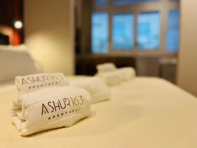 a row of white towels sitting on a bed at Ashur 163 - Mondello in Palermo