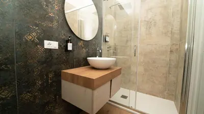 a bathroom with a sink and a mirror at Manere Suites in Palermo