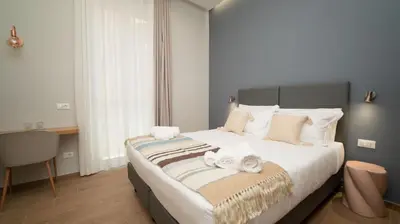 a bedroom with a large bed with towels on it at Manere Suites in Palermo