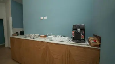 a counter with a coffee maker and cups on it at Manere Suites in Palermo