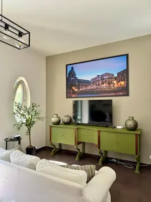 a living room with a white couch and a flat screen tv at Flat44 in Palermo