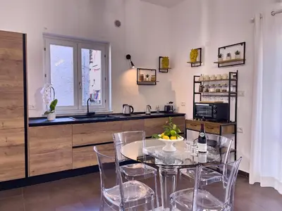a kitchen with a table and chairs and a counter at Flat44 in Palermo