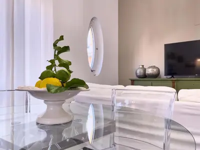 a glass table with a bowl of lemons on it at Flat44 in Palermo