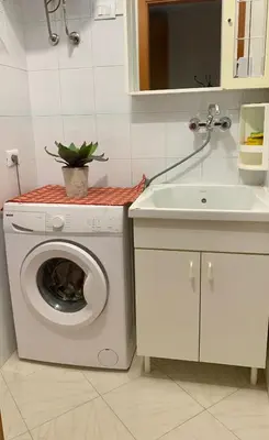 a kitchen with a washing machine and a sink at Campofelice Happy Casa in Campofelice di Roccella