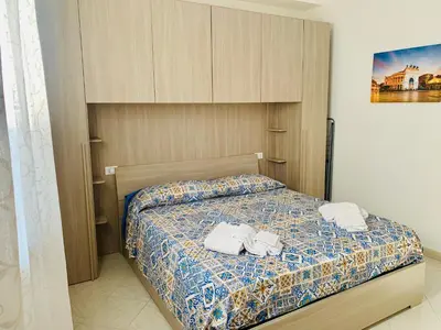 a bedroom with a bed with towels on it at Campofelice Happy Casa in Campofelice di Roccella
