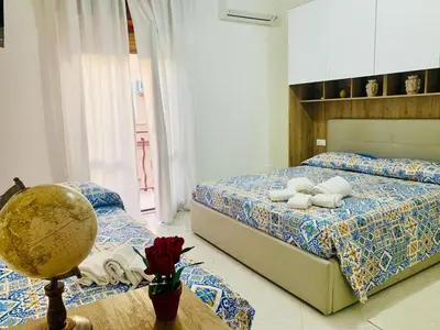 a bedroom with two beds and a globe on a table at Campofelice Happy Casa in Campofelice di Roccella