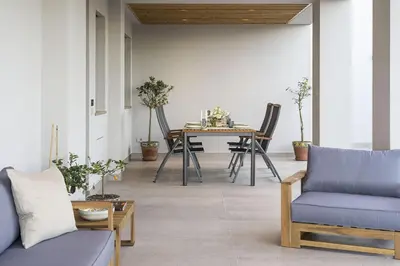a living room with a table and chairs at Villa Bizzarria in Castellammare del Golfo