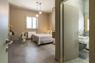 a bedroom with a bed and a sink in a room at Villa Bizzarria in Castellammare del Golfo