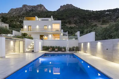 a villa with a swimming pool in front of a house at Villa Bizzarria in Castellammare del Golfo