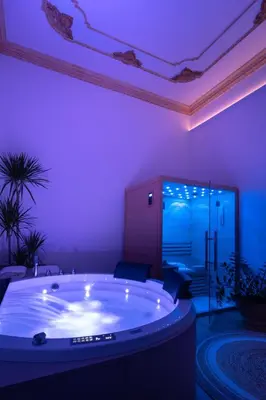 a jacuzzi tub in a room with purple lighting at Libertà 78 - Art Suite & Spa in Palermo