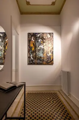 a museum exhibit with a painting on the wall at Libertà 78 - Art Suite & Spa in Palermo