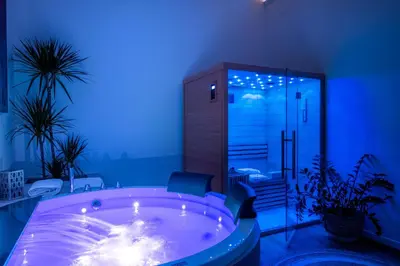 a jacuzzi tub in a room with blue lights at Libertà 78 - Art Suite & Spa in Palermo
