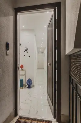 an open door to a hallway with a white tile floor at Mariblu Palermo in Palermo