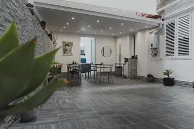 a living room with a table and chairs at Mariblu Palermo in Palermo